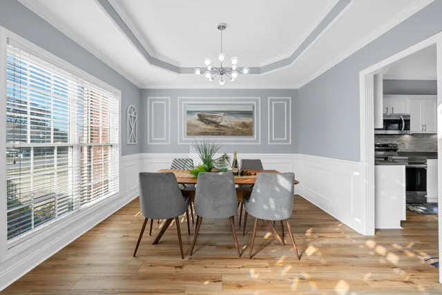 a view of a dining room with furniture and wooden floor