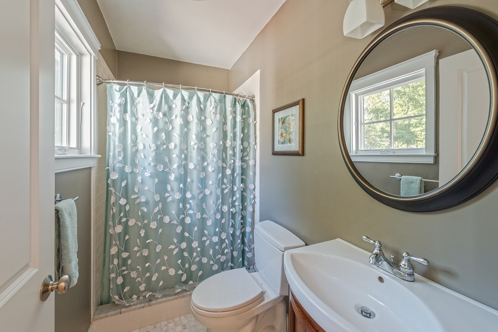 3 Turkey Shore Road Ipswich, MA 01938 - Photo 17 of 21 a bathroom with a toilet a sink a mirror a window and shower