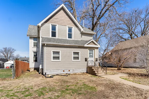 a view of a house with a yard covered in snow