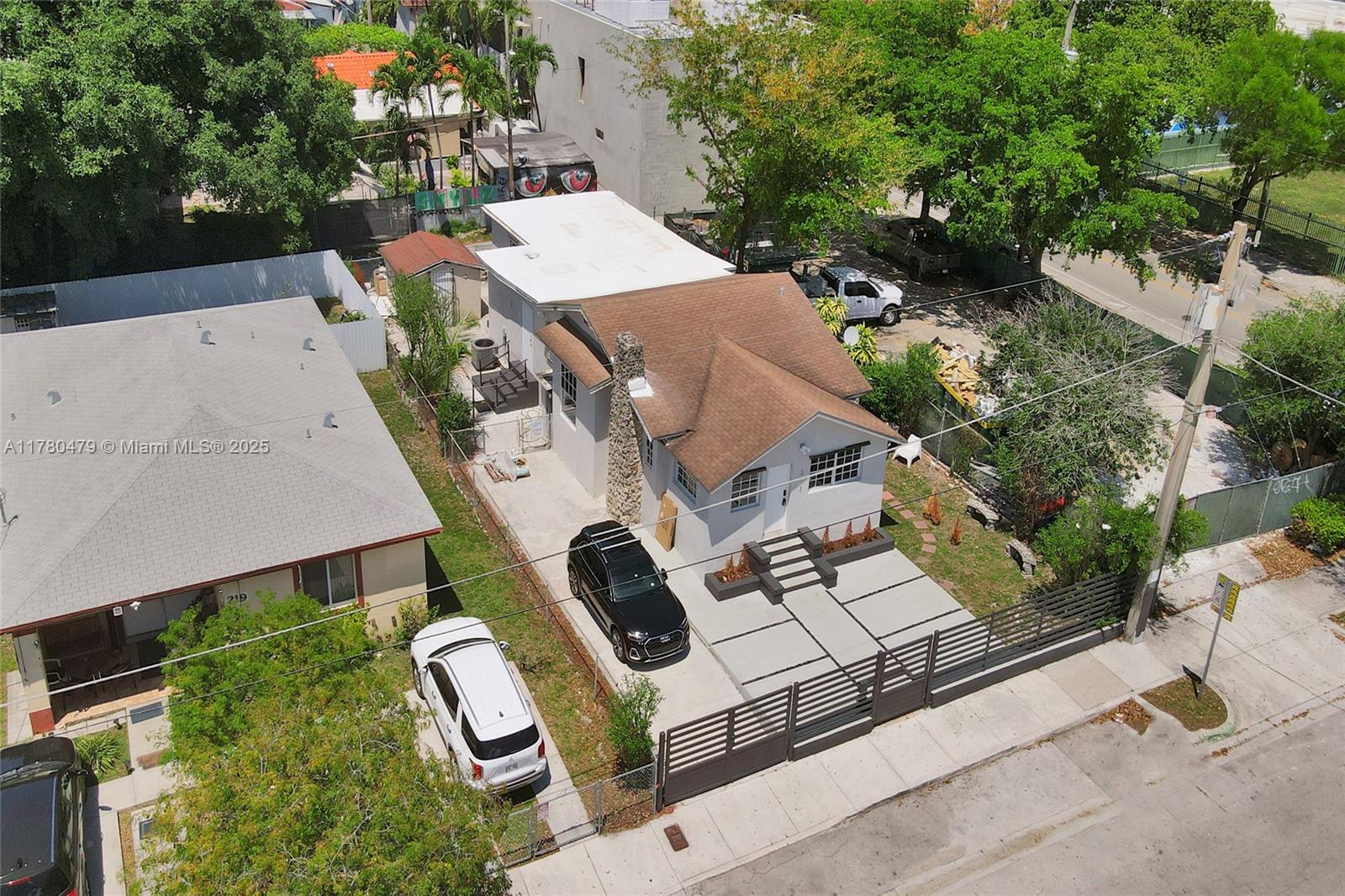 213 Northwest 34th Terrace Miami, FL 33127 - Photo 11 of 18 an aerial view of a house with swimming pool and large trees