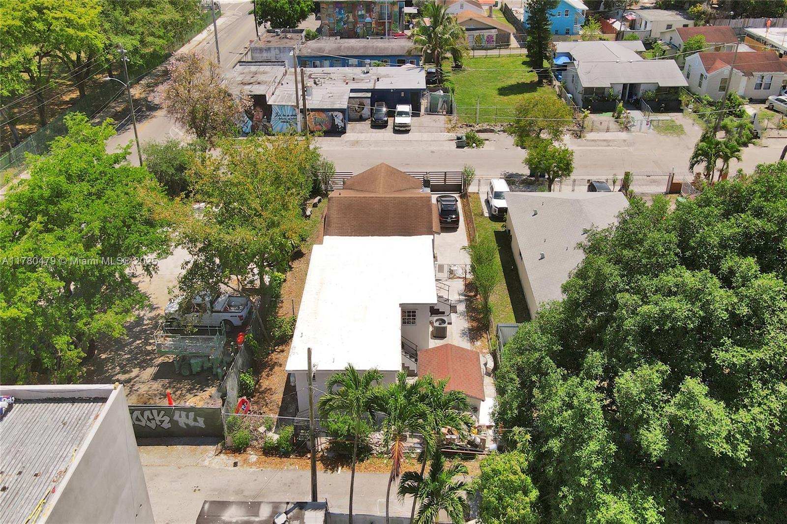 213 Northwest 34th Terrace Miami, FL 33127 - Photo 16 of 18 an aerial view of multiple houses with yard