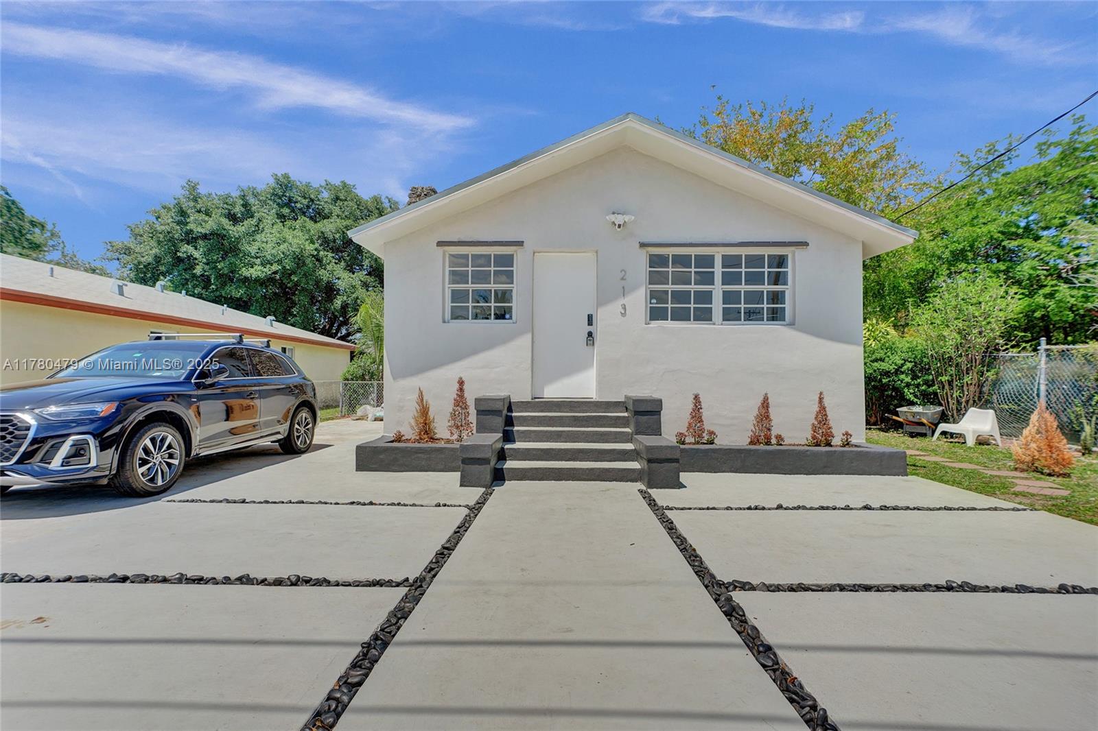 213 Northwest 34th Terrace Miami, FL 33127 - Photo 2 of 18 a view of a car parked in front of a house