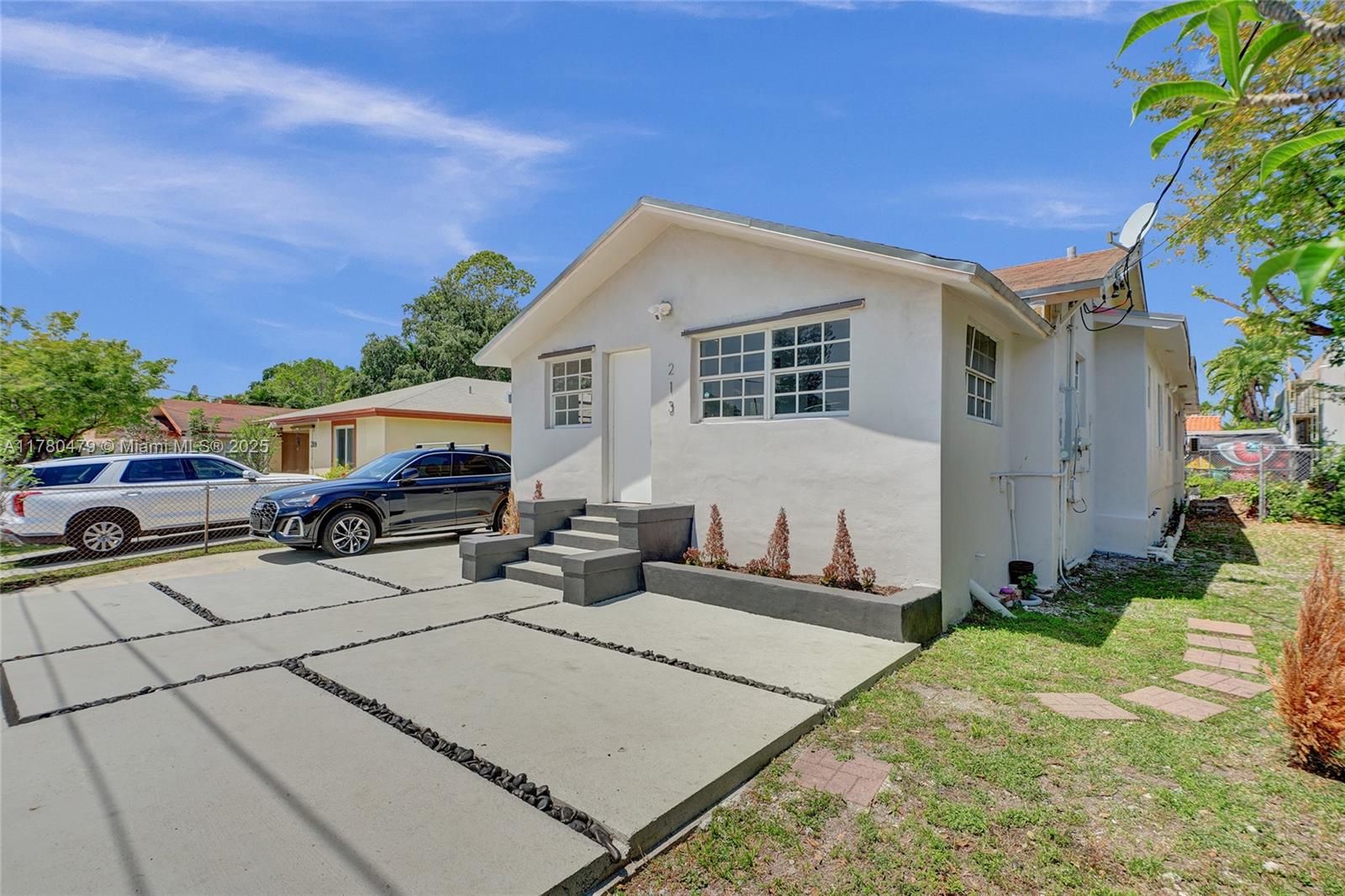 213 Northwest 34th Terrace Miami, FL 33127 - Photo 3 of 18 a front view of a house with a yard