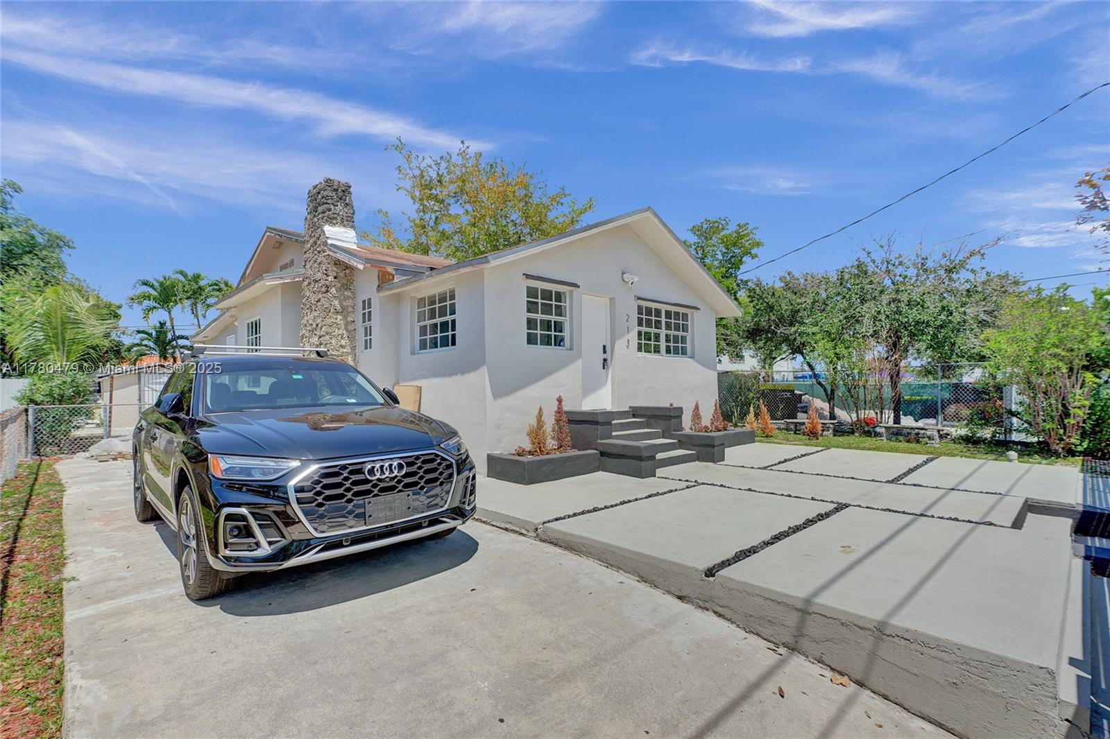 213 Northwest 34th Terrace Miami, FL 33127 - Photo 4 of 18 a car parked in front of a house