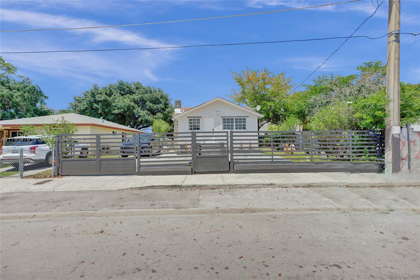 213 Northwest 34th Terrace Miami, FL 33127 - Photo 6 of 18 a view of a house with a yard and potted plants