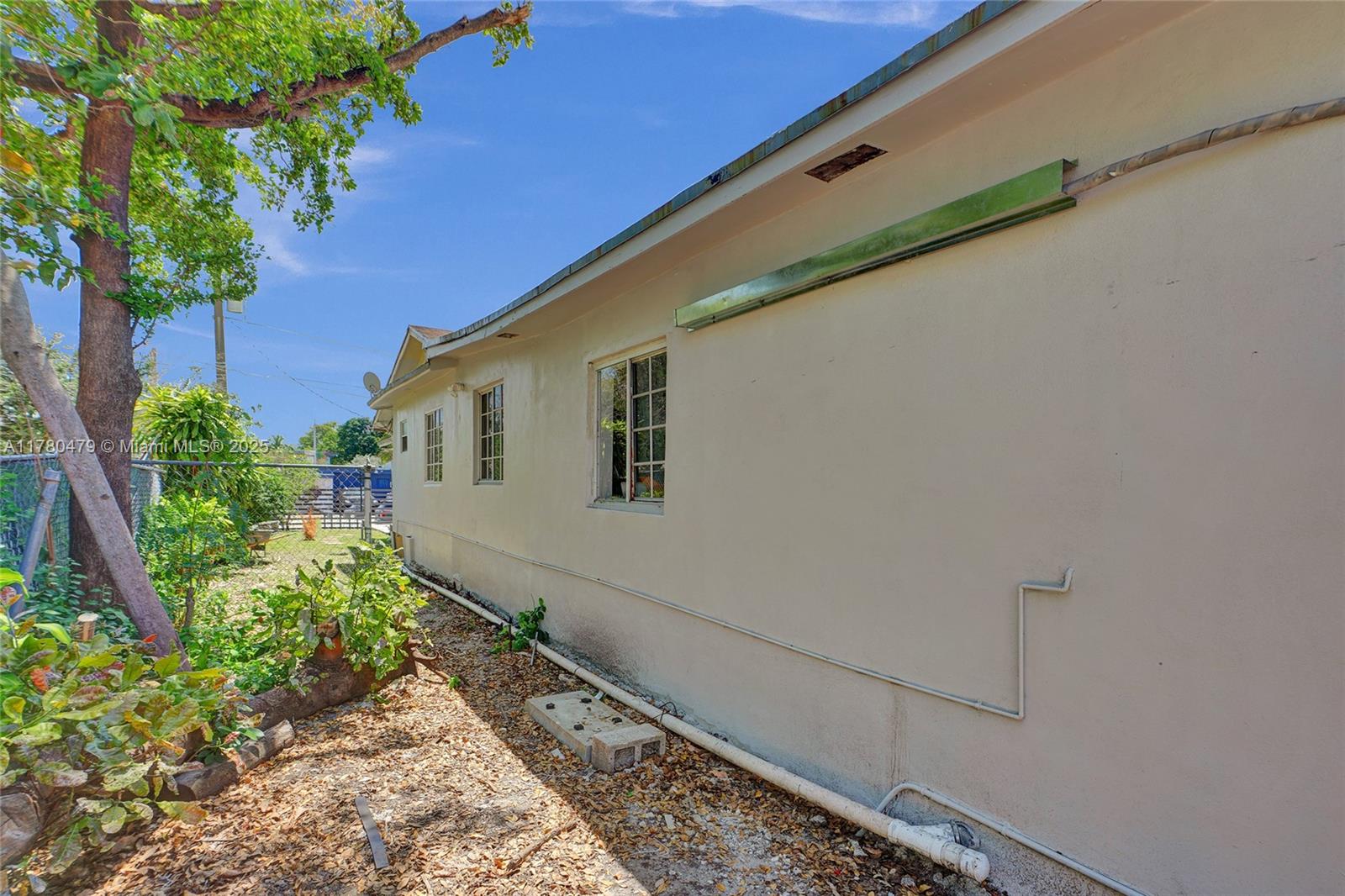 213 Northwest 34th Terrace Miami, FL 33127 - Photo 8 of 18 a house with a yard