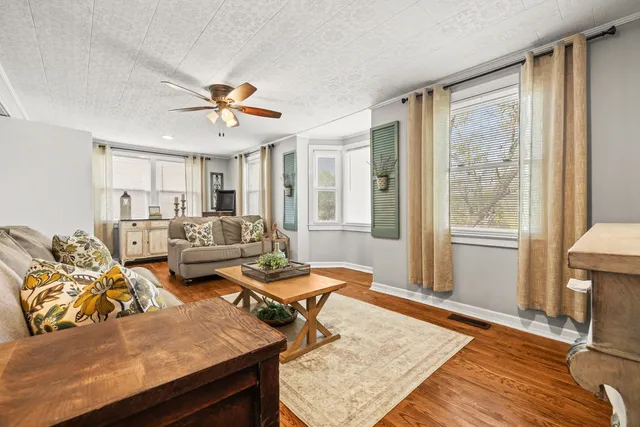a living room with furniture and a fireplace