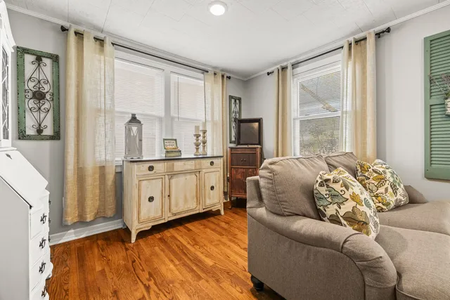 a living room with furniture and large windows