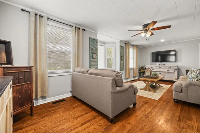 a living room with furniture fireplace and a flat screen tv