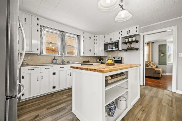 a kitchen with stainless steel appliances granite countertop a stove and a sink