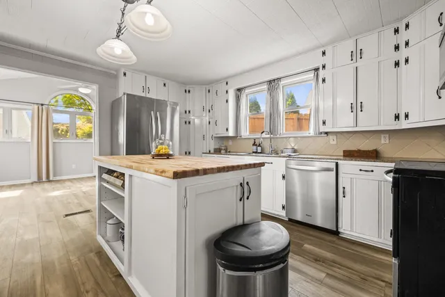 a kitchen with a sink stove and cabinets