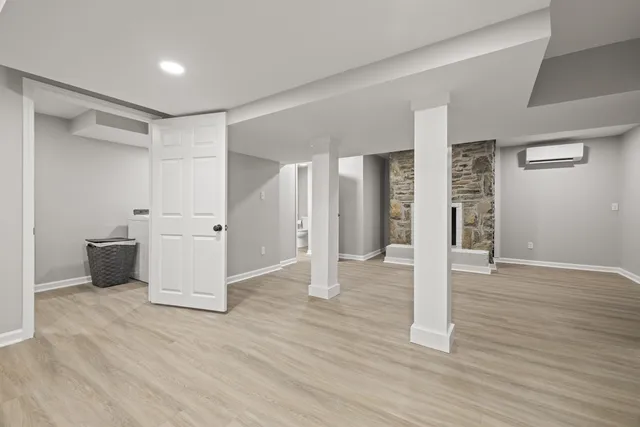 a view of a big room with wooden floor and windows