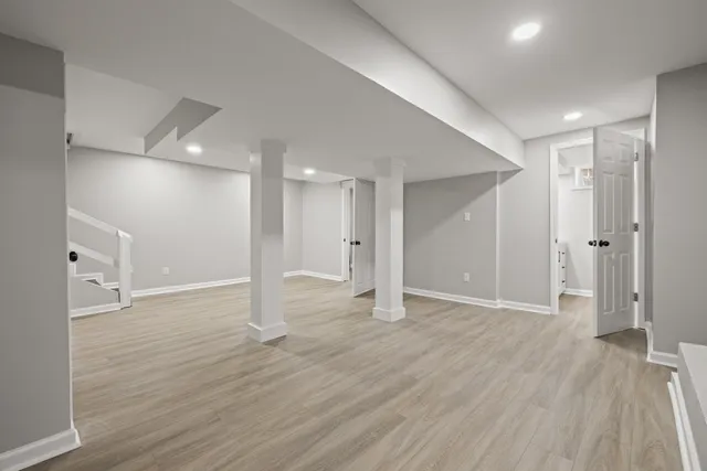 a view of an empty room with wooden floor