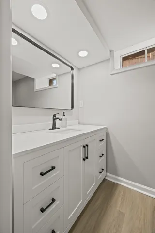 a bathroom with a double vanity sink and mirror
