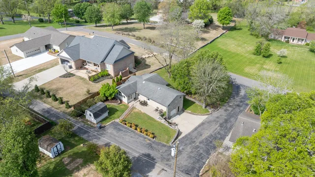 an aerial view of a house with a yard