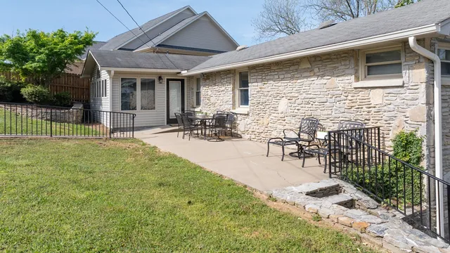 a view of a patio with table and chairs with wooden fence