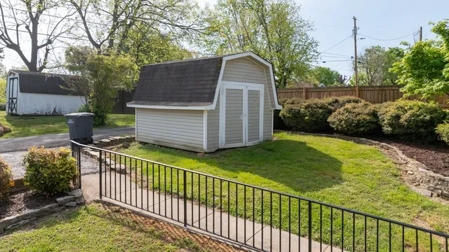 a view of a house with a wooden fence
