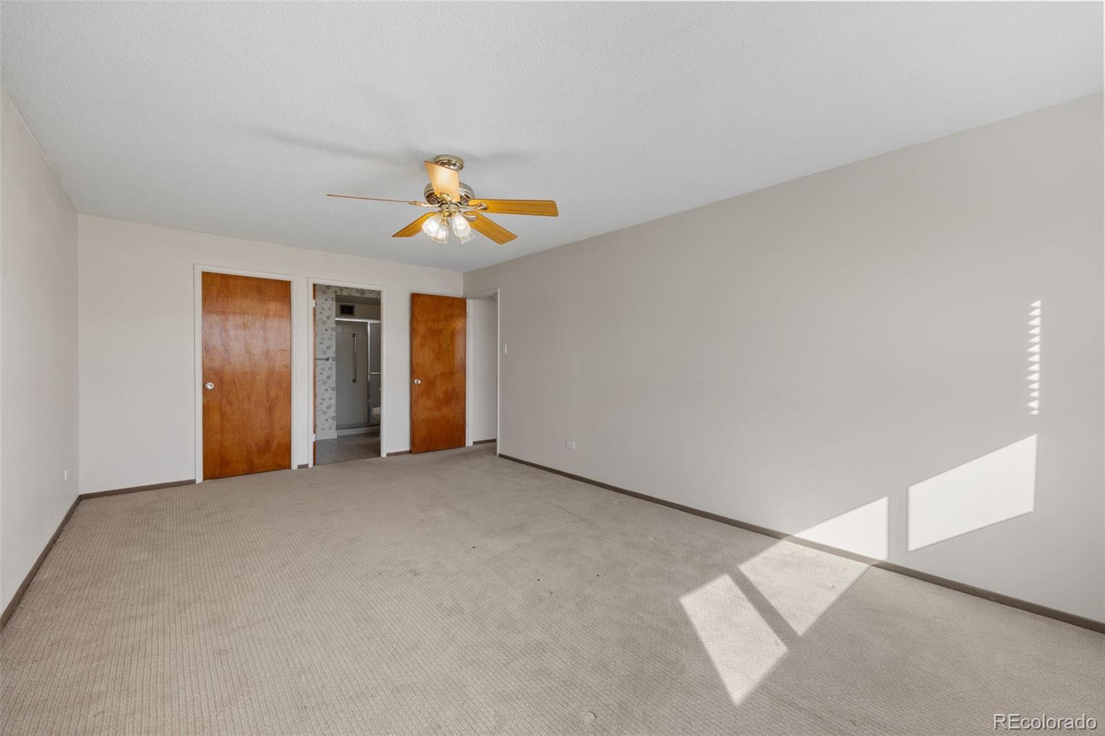 650 South Alton Way, Unit 3B Denver, CO 80247 - Photo 11 of 19 an empty room with a ceiling fan and a window