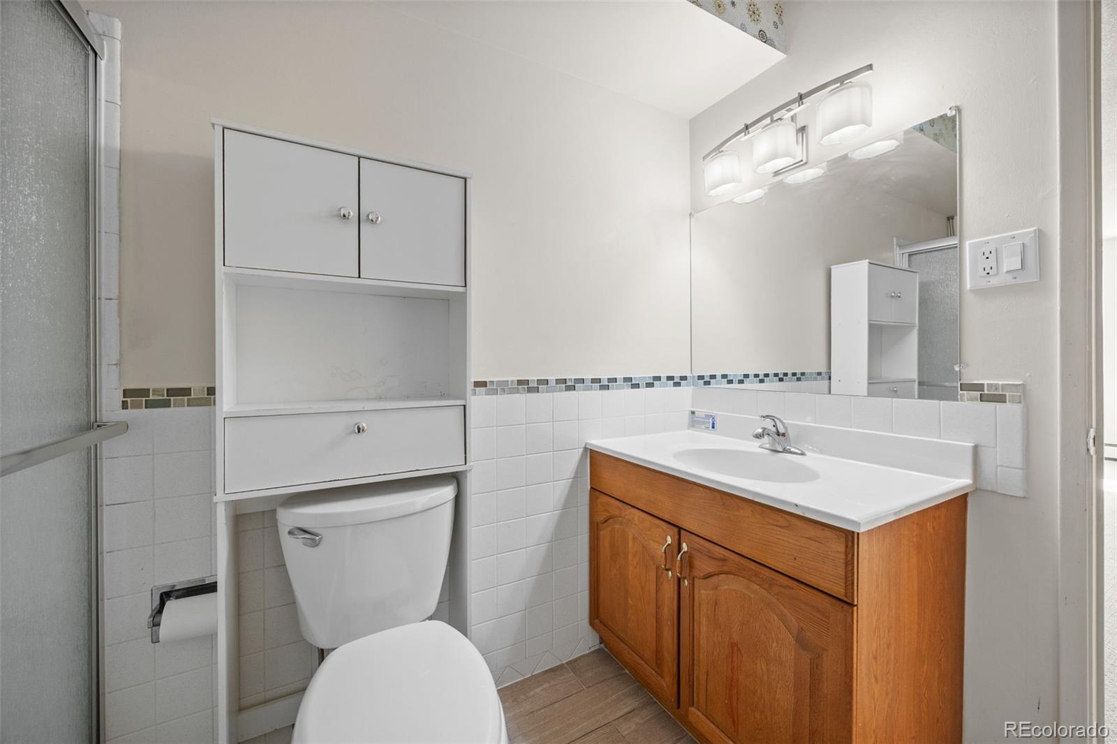 650 South Alton Way, Unit 3B Denver, CO 80247 - Photo 13 of 19 a bathroom with a toilet sink vanity granite and mirror