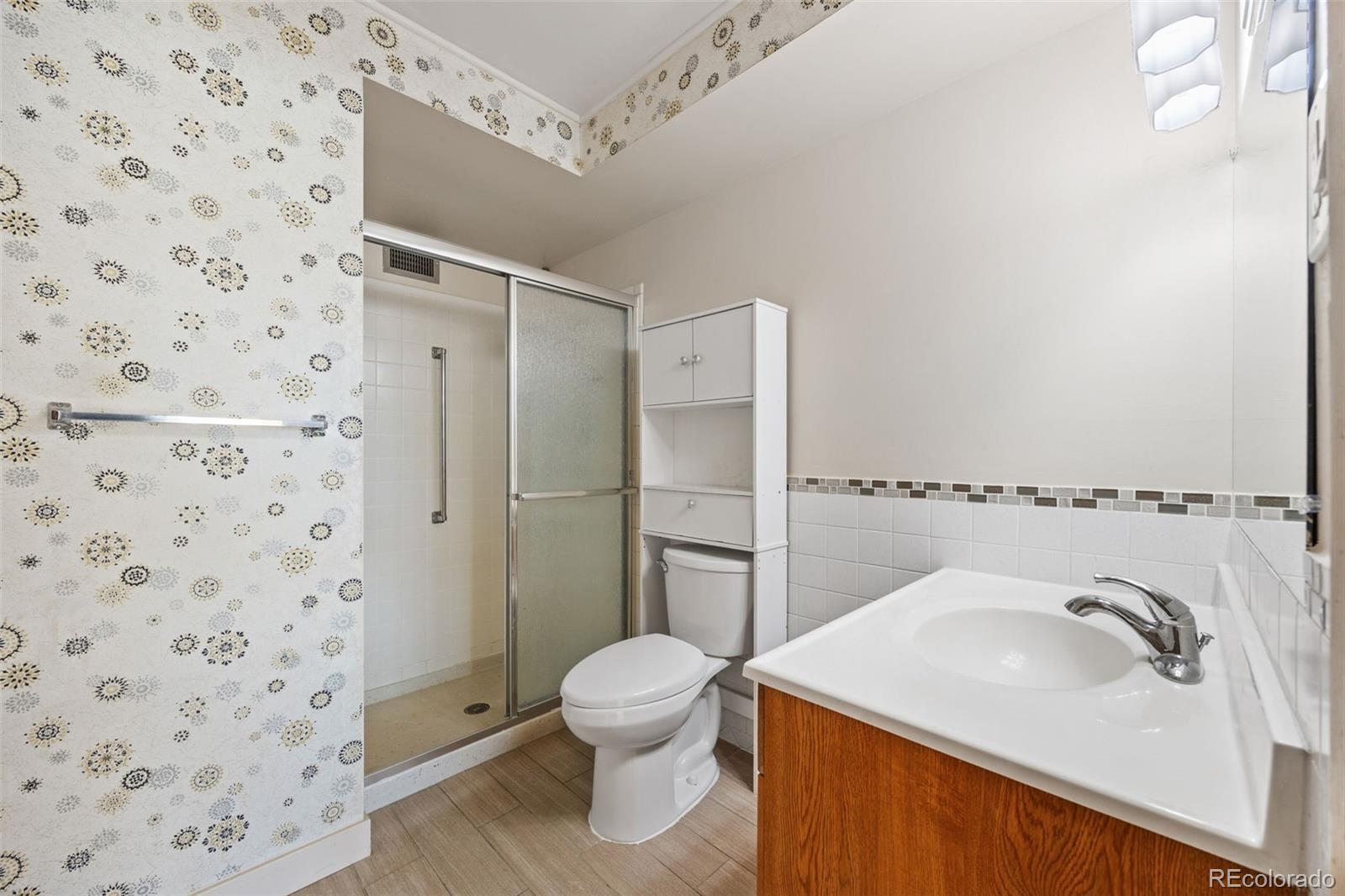 650 South Alton Way, Unit 3B Denver, CO 80247 - Photo 15 of 19 a bathroom with a sink toilet and shower