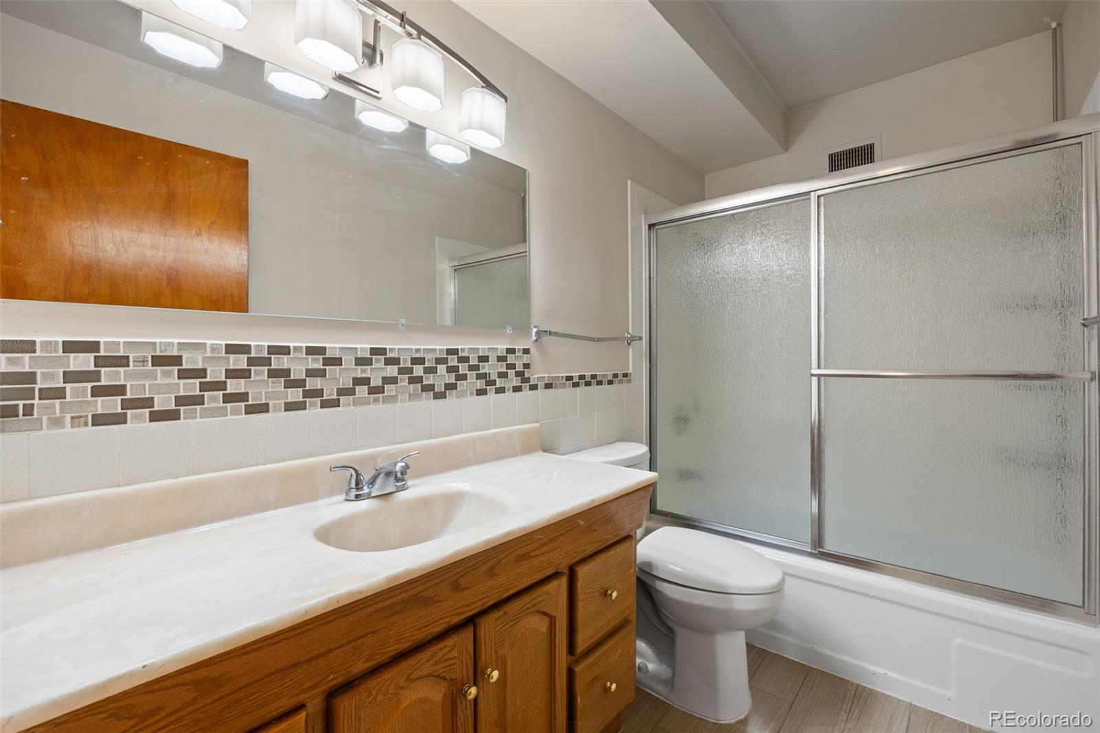 650 South Alton Way, Unit 3B Denver, CO 80247 - Photo 16 of 19 a bathroom with a sink toilet and shower