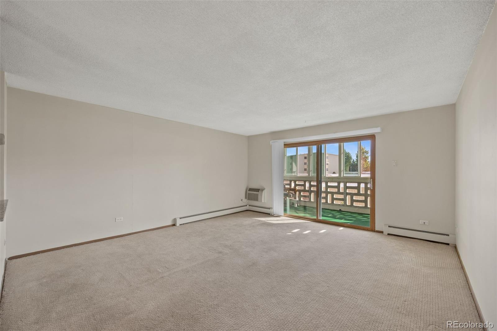 650 South Alton Way, Unit 3B Denver, CO 80247 - Photo 5 of 19 a view of an empty room with a window