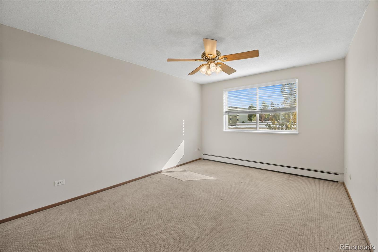 650 South Alton Way, Unit 3B Denver, CO 80247 - Photo 8 of 19 an empty room with windows and fan