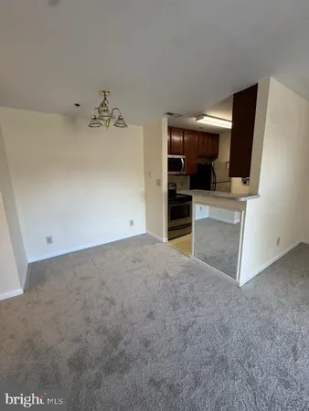 a view of a bedroom with cabinet flat screen tv and closet