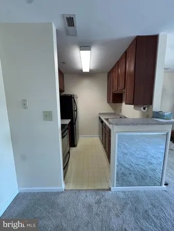 a kitchen with stainless steel appliances granite countertop a stove a refrigerator and a sink