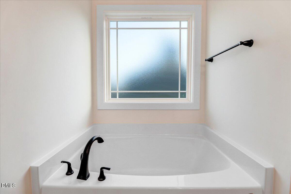 254 Galway Road Lillington, NC 27546 - Photo 25 of 35 a white bath tub sitting next to a window