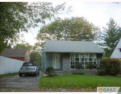115 McFarlane Road Colonia, NJ 07067 - Photo 1 of 8 a front view of a house with a garden