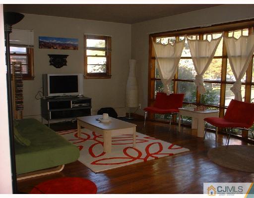 115 McFarlane Road Colonia, NJ 07067 - Photo 2 of 8 a view of a dining room with furniture window and wooden floor