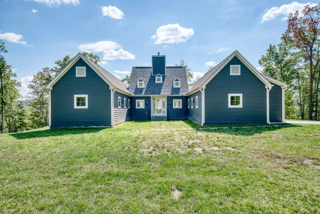 a view of a house with a yard and garage