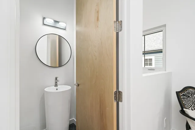 a bathroom with a sink vanity and a mirror