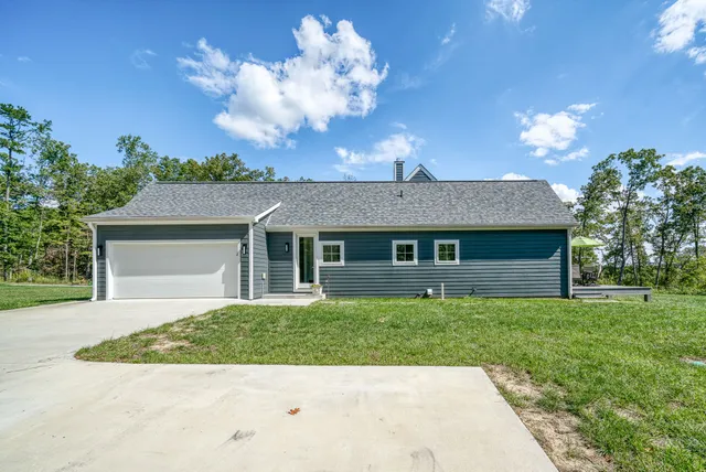 a view of a yard with a building in the background