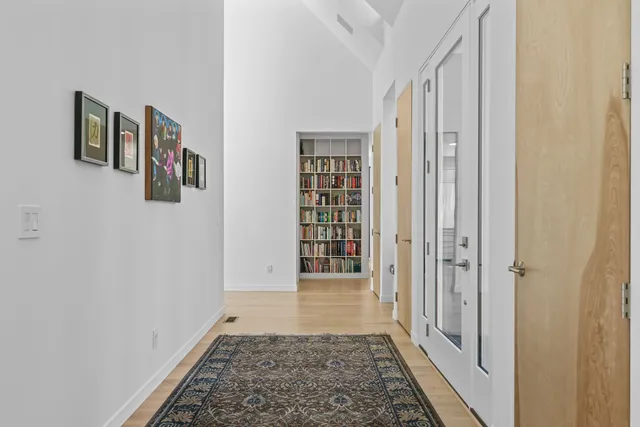 a dining room with furniture a rug and a floor to ceiling window