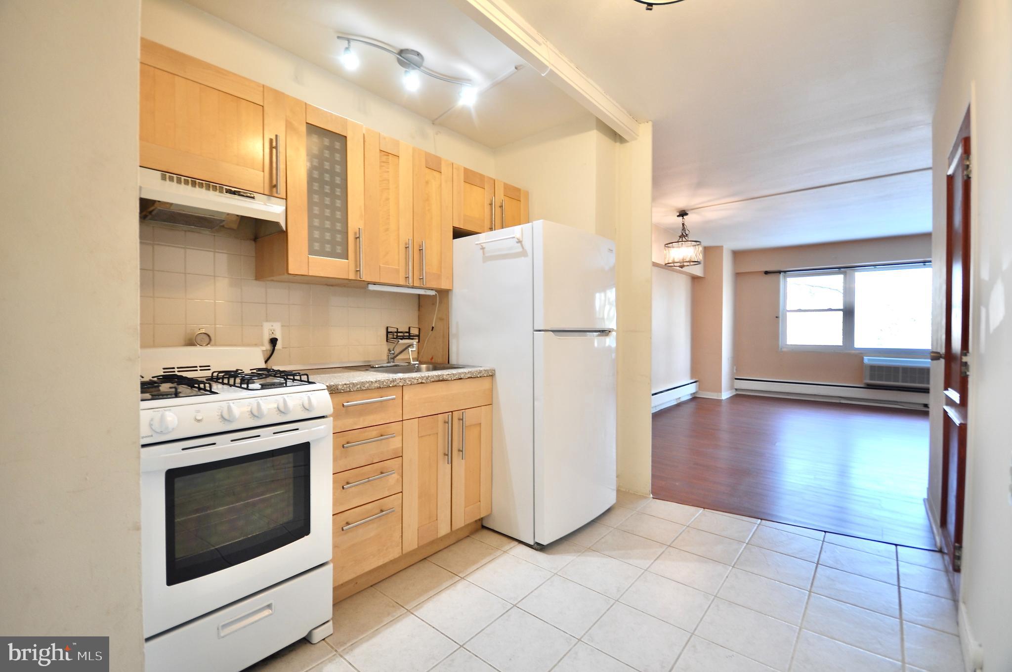 7900 Old York Road, Unit 608B Elkins Park, PA 19027 - Photo 1 of 19 a kitchen with a stove top oven and refrigerator