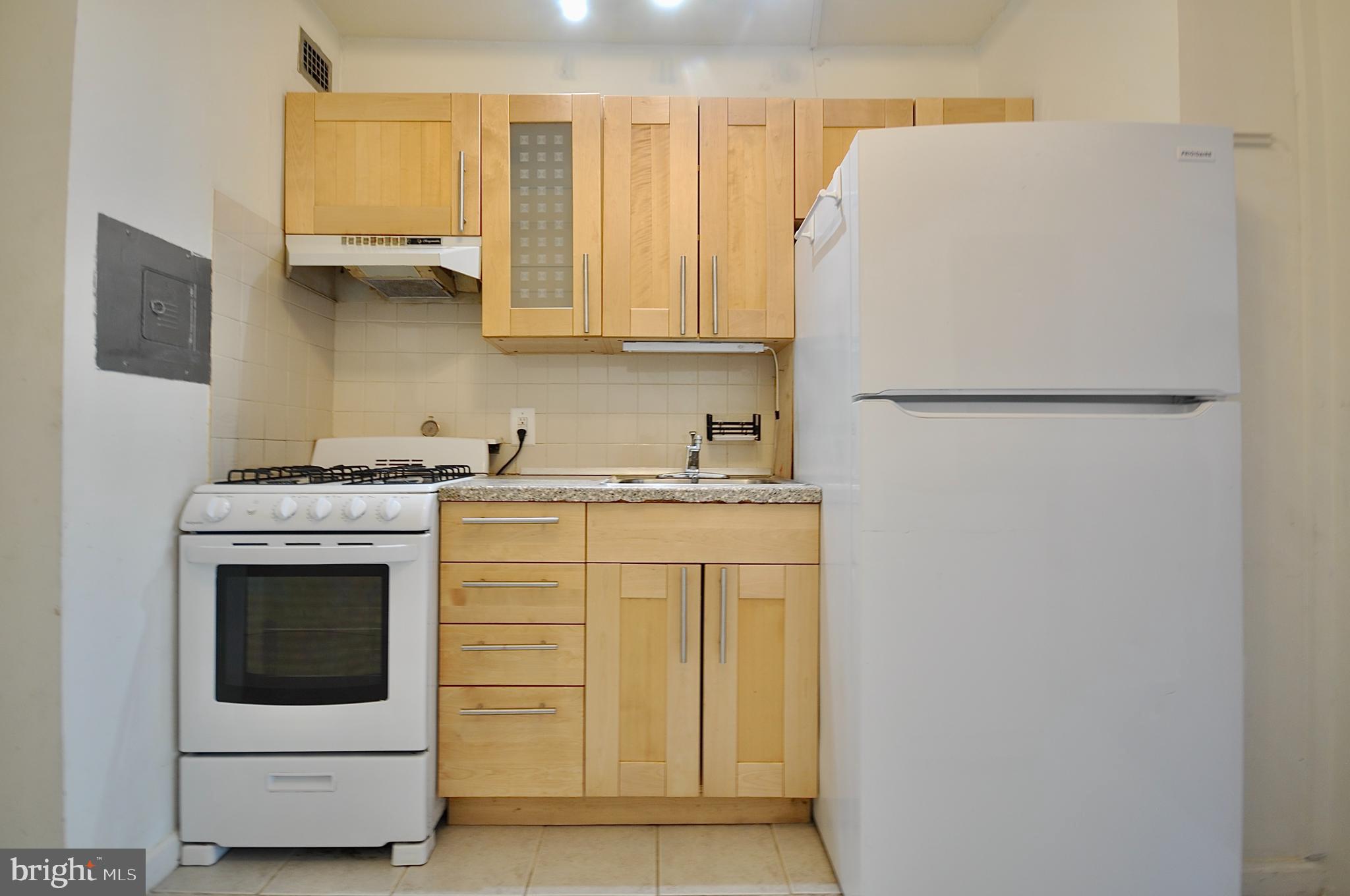 7900 Old York Road, Unit 608B Elkins Park, PA 19027 - Photo 13 of 19 a white refrigerator freezer sitting in a kitchen