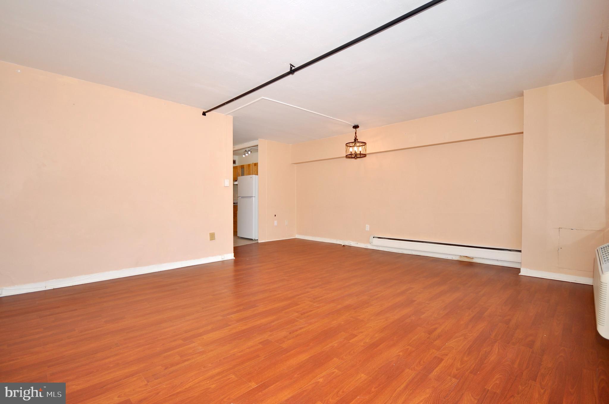 7900 Old York Road, Unit 608B Elkins Park, PA 19027 - Photo 5 of 19 an empty room with wooden floor and windows
