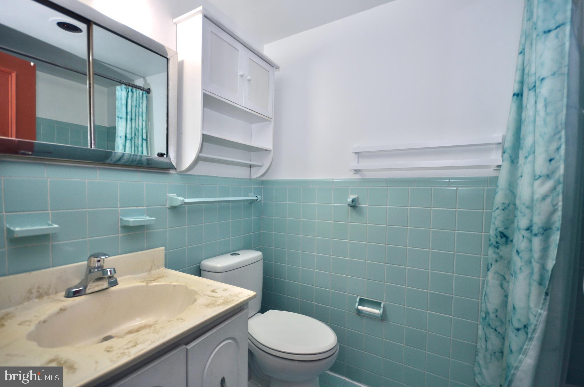 7900 Old York Road, Unit 608B Elkins Park, PA 19027 - Photo 10 of 19 a bathroom with a sink a toilet and a mirror