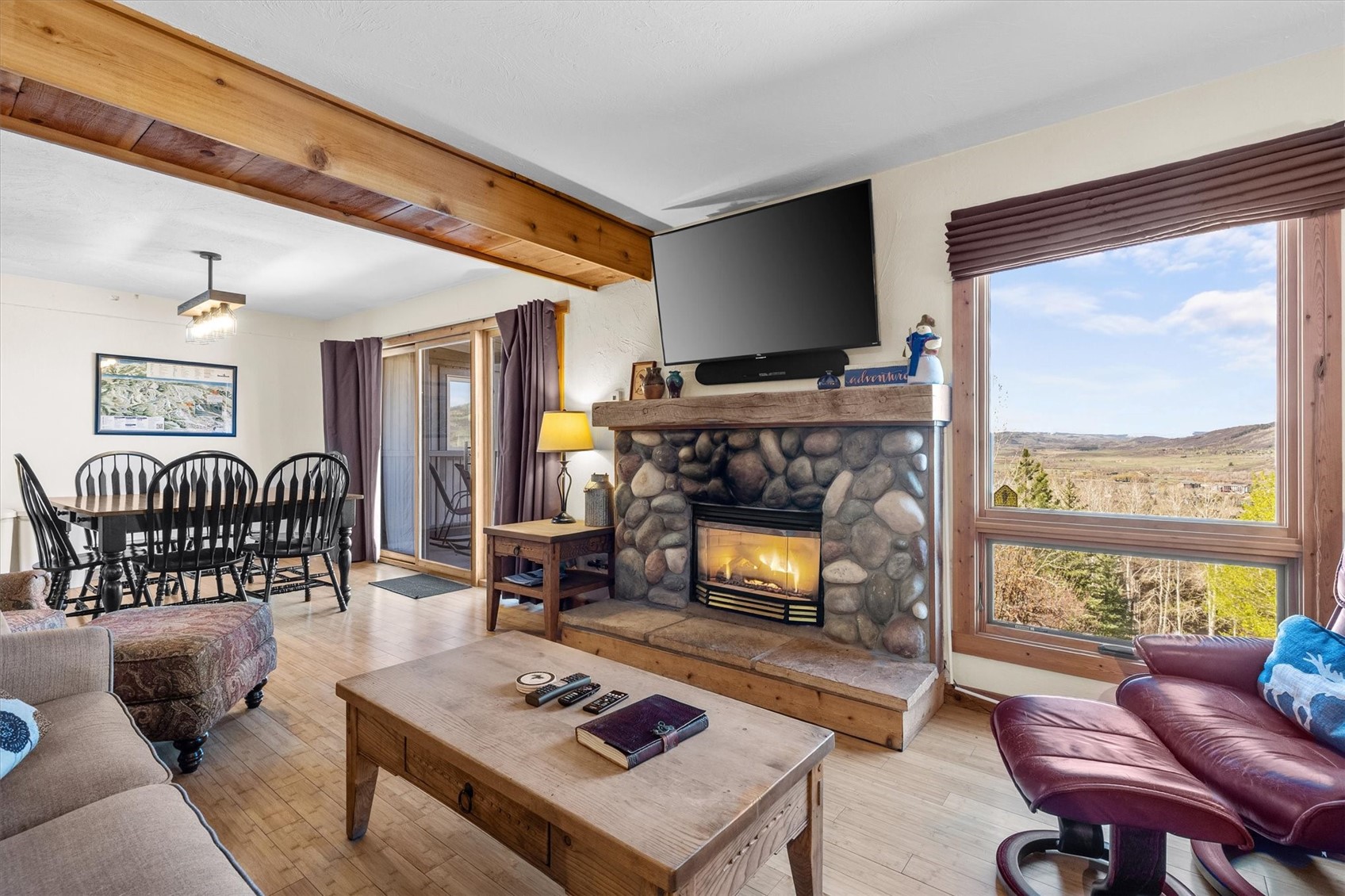 2602 Longthong Road, Unit 107 Steamboat Springs, CO 80487 - Photo 3 of 32 a living room with furniture a flat screen tv and a fireplace