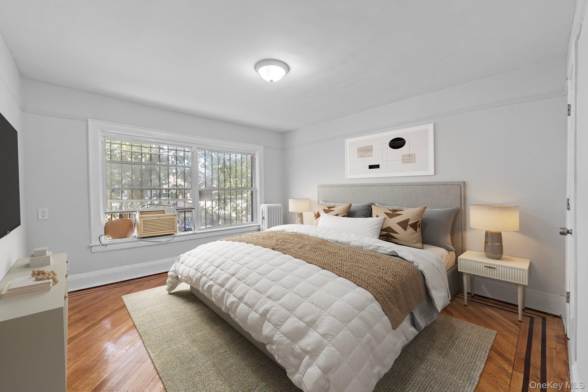 1069 East 35th Street Brooklyn, NY 11210 - Photo 8 of 16 Bedroom featuring radiator heating unit and wood finished floors