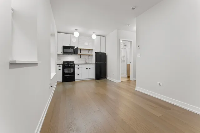 a view of a kitchen with a sink and a refrigerator