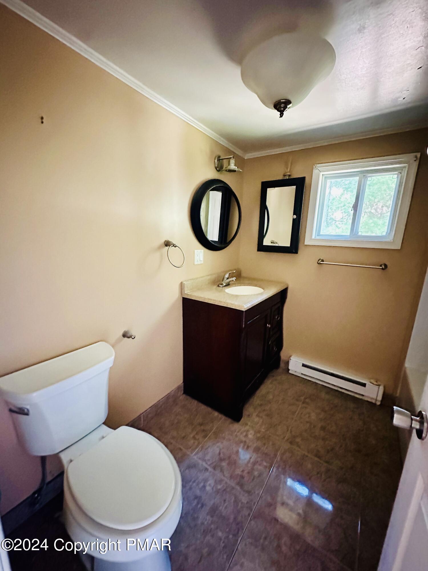 155 Sunrise Drive Milford, PA 18337 - Photo 12 of 16 a bathroom with a toilet a sink and mirror