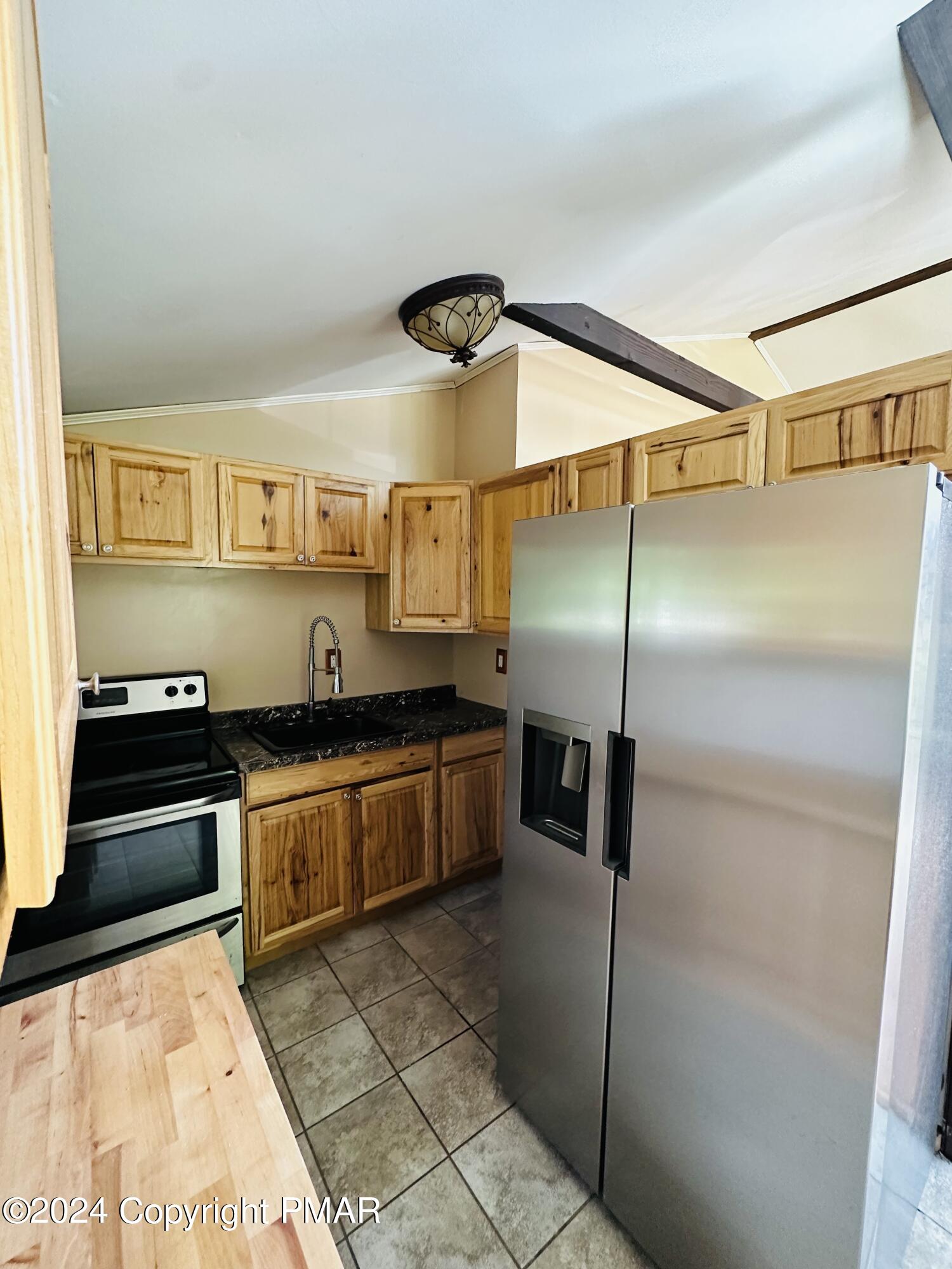 155 Sunrise Drive Milford, PA 18337 - Photo 3 of 16 a kitchen with stainless steel appliances granite countertop a refrigerator and a stove