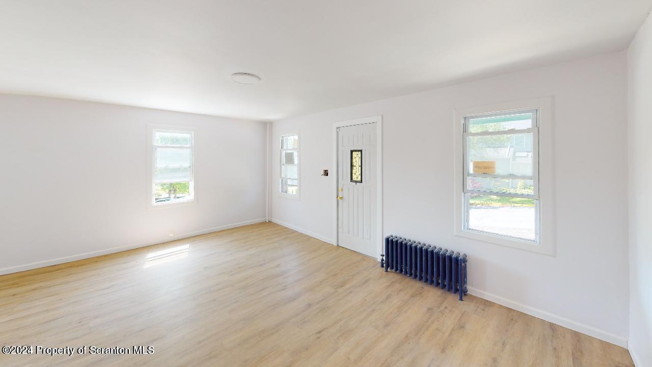 400 3rd Street Archbald, PA 18403 - Photo 12 of 15 a view of an empty room with wooden floor and a window