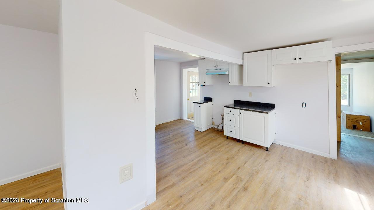 400 3rd Street Archbald, PA 18403 - Photo 13 of 15 a kitchen with wooden floor and electronic appliances