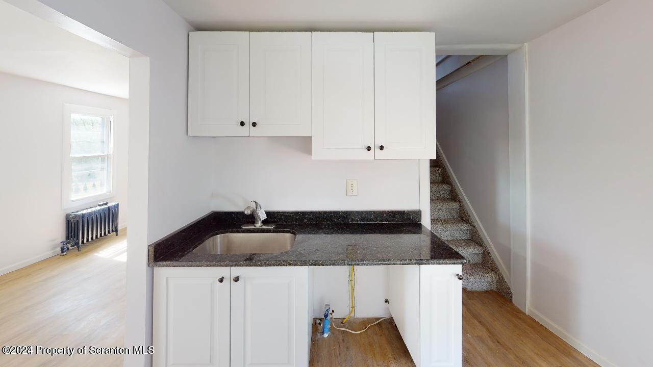 400 3rd Street Archbald, PA 18403 - Photo 14 of 15 a kitchen with sink and cabinets