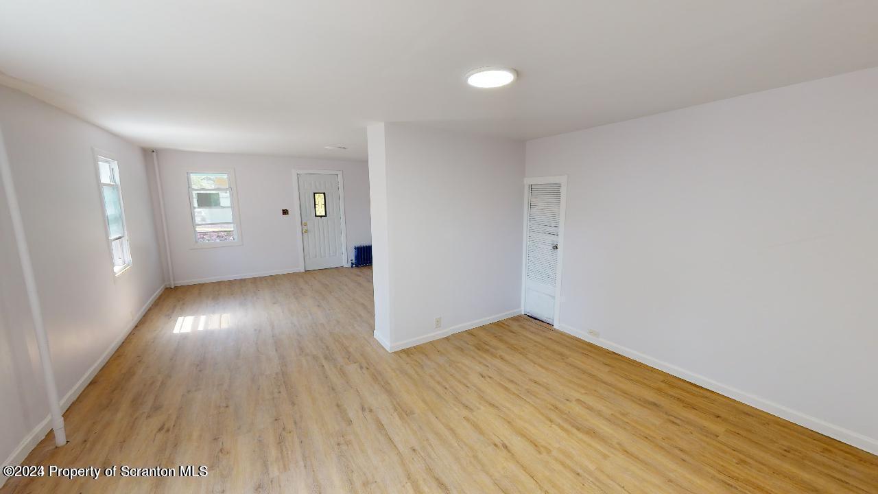 400 3rd Street Archbald, PA 18403 - Photo 4 of 15 an empty room with wooden floor and windows