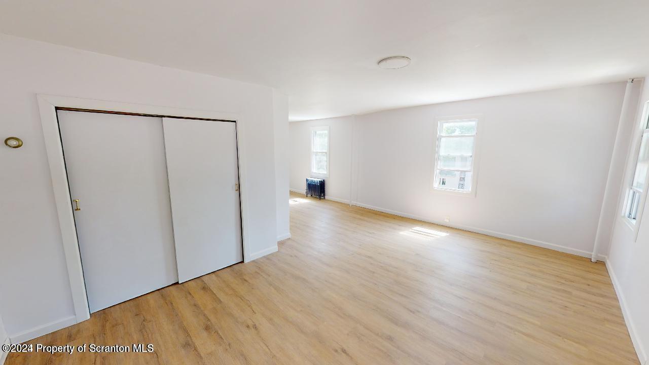400 3rd Street Archbald, PA 18403 - Photo 5 of 15 a view of a big room with wooden floor and windows